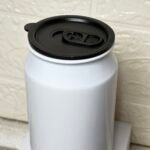 A white cup shaped like a Pepsi can